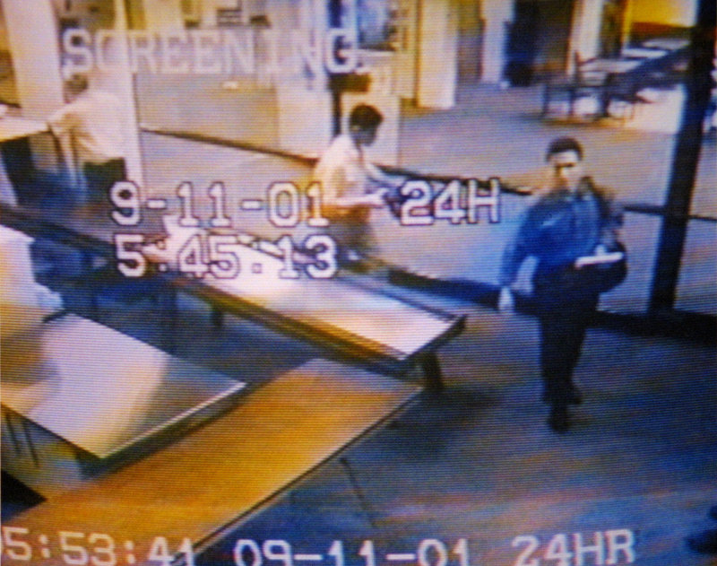 Two men identified by authorities as hijackers Mohammed Atta, right, and Abdulaziz Alomari, center, pass through airport security Sept. 11, 2001, at Portland International Jetport in this image from airport surveillance tape.