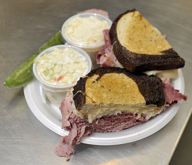 Order the corned beef Reuben special from Full Belly Deli on Brighton Avenue in Portland, and the hefty sandwich arrives accompanied by some sidekicks – a pickle, coleslaw and potato salad.