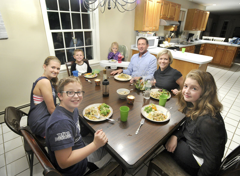 The Peterson family sits down for a dinner of creamy vegan “chicken” casserole with chopped-pumpkin-seed tossed salad recently at their Portland home. Clockwise from lower left, Bryant Peterson, 13, Madison Legassey 13, Brady Peterson, 4, Gabriela Peterson, 2, Jeff Peterson, Laura Peterson and Carly Peterson, 12.
