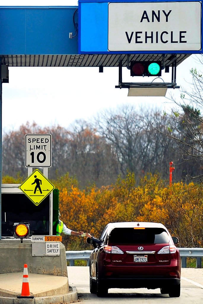 Paul Norton collects a toll at Exit 46 from a driver heading south on the turnpike Wednesday afternoon. Scheduled toll increases took effect at 12:01 a.m. Thursday.