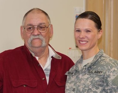 Larry Huff, 67, of Westbrook stands with Pfc. Lisa Bryant of Scarborough, a Maine Army National Guard medic who was honored Thursday for saving Huff’s life after she saw his minivan crash on Interstate 295 in August.