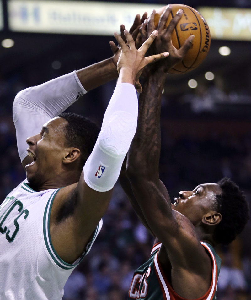 Boston Celtics forward Jeff Green, left, reaches back as Milwaukee Bucks forward Larry Sanders grabs the rebound during the first quarter in Boston on Friday.