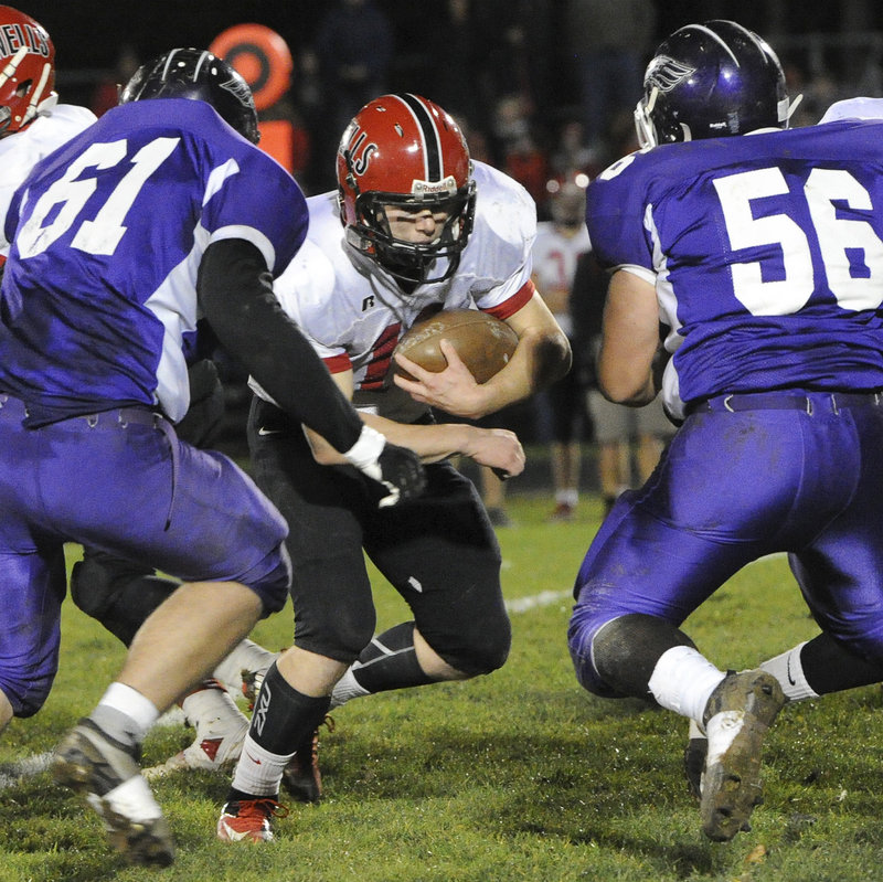 Dante Fanning tries to cut through rugged Marshwood defenders Eric Pratt (61) and Tyler Gagnon (56). Marshwood’s defense, so vulnerable earlier in the season against Wells, stiffened considerably in the rematch.