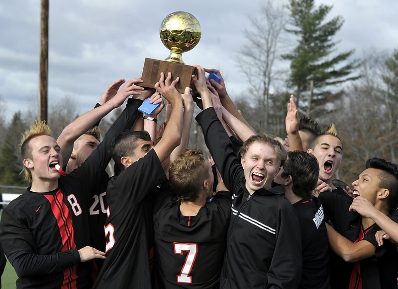 Scarborough’s boys’ soccer team celebrates after it capped an unbeaten season with a 4-0 triumph over Mt. Ararat in the Class A state championship game.