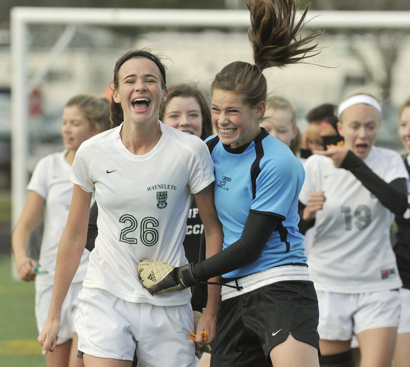 Believe it. It's true. Waynflete is the Class C girls' soccer state champion, and Sadie Cole, left, and keeper Jilianna Harwood couldn't hide their smiles.