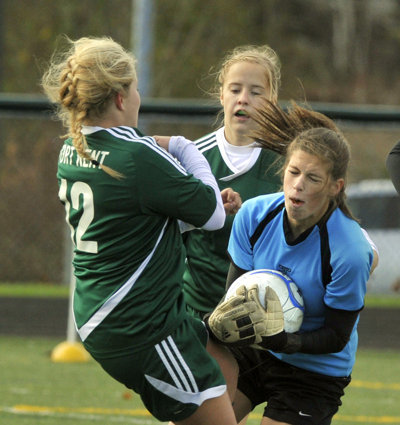 Juliana Harwood of Waynflete grabs a loose ball before Steffany Paradis, left, and Jessica Moring of Fort Kent during the Class C state final at Scarborough.