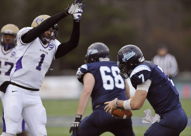 Maine quarterback Marcus Wasilewski (7) is unable to avoid James Madison safety Titus Till (1) who got the sack in the first half of Saturday’s game.