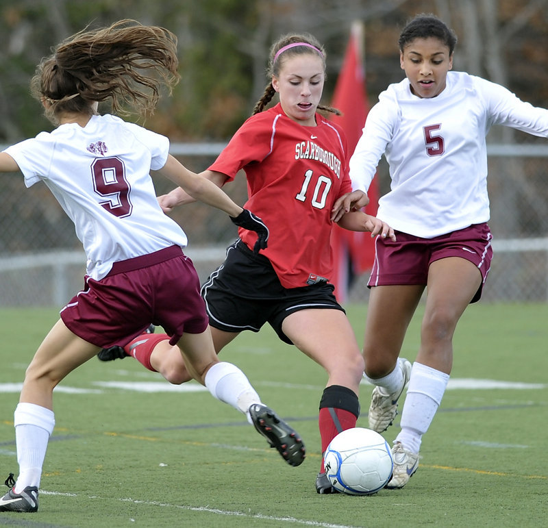 Jessica Meader of Scarborough tries some fancy footwork to get past Bangor defenders Anna-Maria Dagher, left, and Denae Johnson during the Red Storm's win in the Class A final.