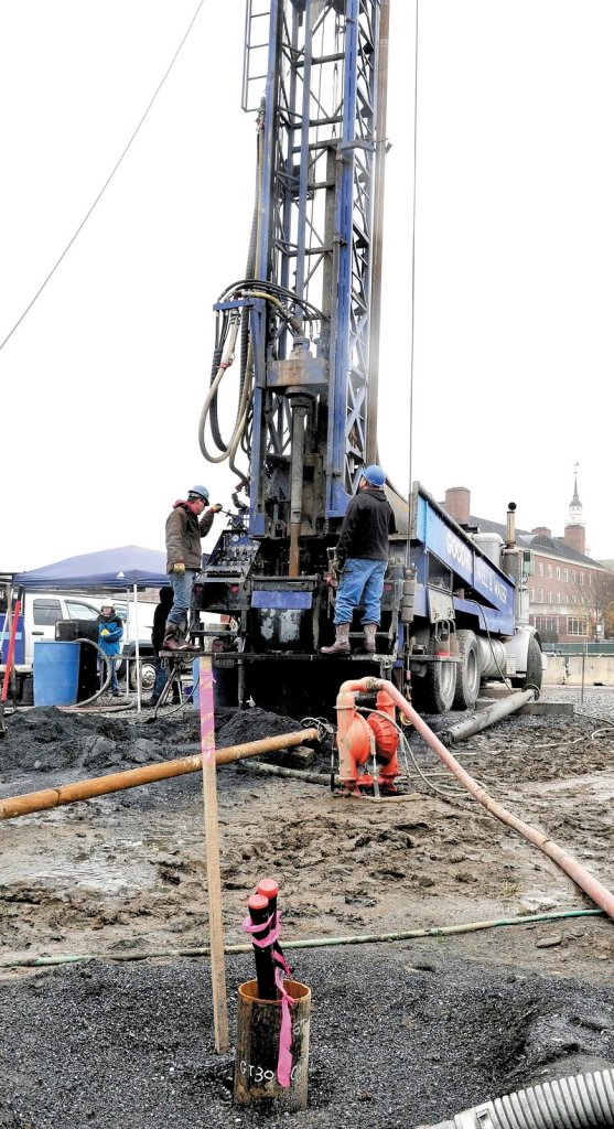 Workers drill holes to install the geothermal system that will help heat the new science building at Colby.