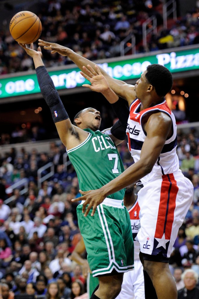 Jared Sullinger of the Celtics launches a shot over Washington’s Kevin Seraphin during first-half action of Saturday’s game, won by Boston 89-86.