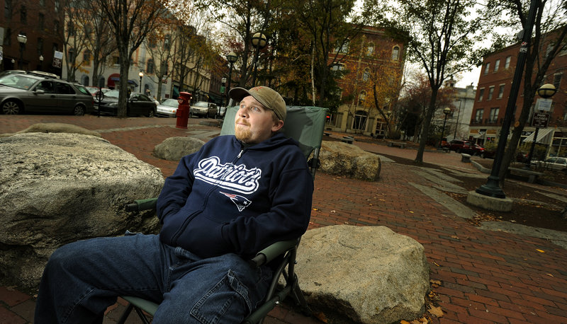 Chris “Benji” Levine, 24, of Portland, waits for customers Monday at his hot dog stand on Middle Street. Levine says he favors Mitt Romney over President Obama, but he is most concerned that the same-sex marriage question passes.