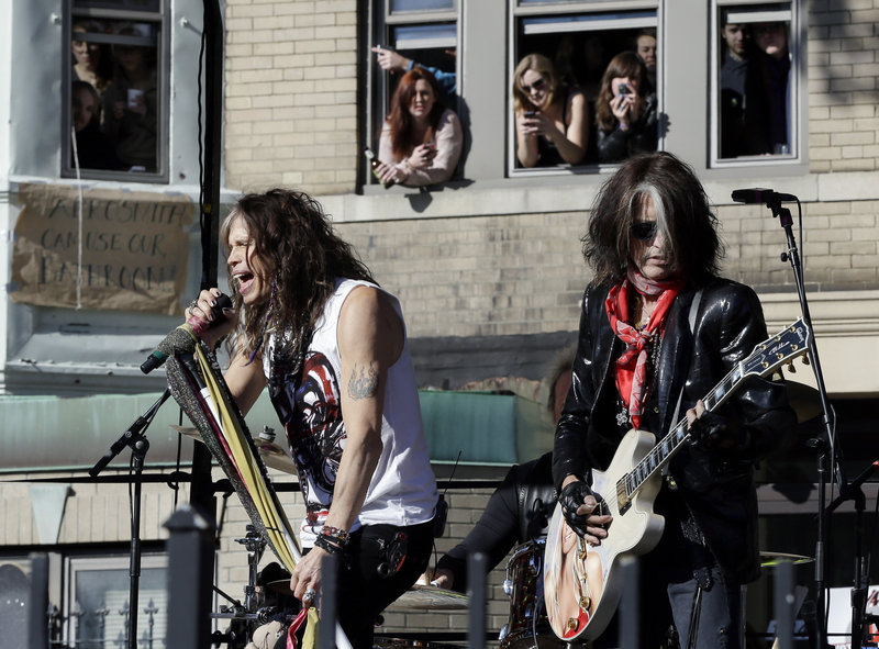 Aerosmith members Steven Tyler, left, and Joe Perry perform Monday, Nov. 5, 2012 in Boston's Allston neighborhood at a free concert by Aerosmith whose band members lived there in the early 1970's. (AP Photo/Elise Amendola)