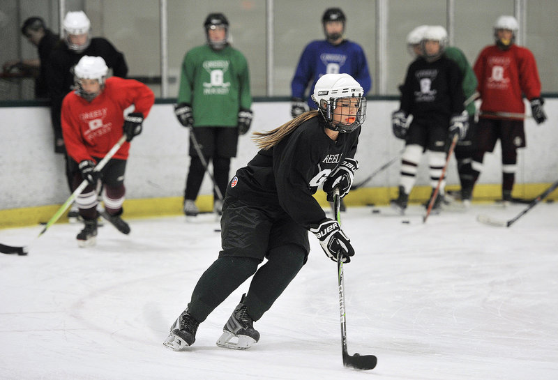 Chelsey Andrews, a Greely senior defenseman, carries the puck during a stick-handling drill Monday – the opening day for high school girls’ hockey practice in Maine. Greely enters the season as the reigning state champion and is expected to be a top contender again.