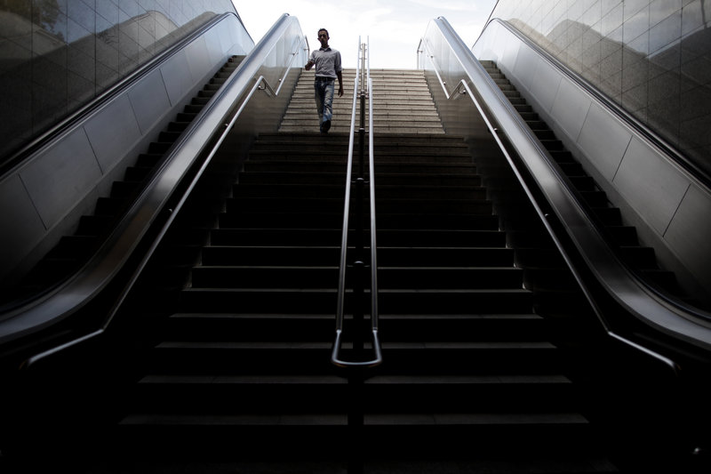 A commuter walks down the stairs of a closed metro station during a 24-hour strike in Athens on Monday. If lawmakers reject austerity measures Wednesday, Greece faces the prospect of losing vital rescue loans.