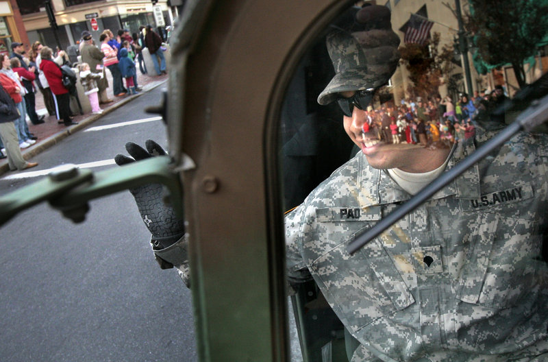 Spc. San Pao, who served in Iraq with the Maine Army National Guard in 2004, waves from a humvee to spectators during the 2006 Veterans Day parade in Portland. “All those men and women who will serve on the tip of the spear ... We owe them everything,” a reader says.