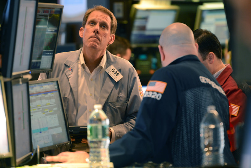 Luke Scanlon of MND Partners Inc. watches stock prices during a volatile day on the floor of the New York Stock Exchange on Wednesday, the day after President Obama was re-elected.