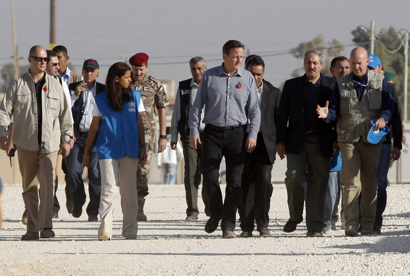 British Prime Minister David Cameron, center, and U.N. officials visit a camp for Syrian refugees in Jordan. Cameron urged allies to work directly with rebel military commanders.