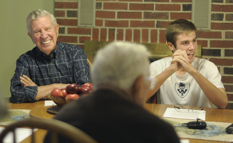 Bill Currier, left, shares a laugh with Westbrook High School junior Morgan Rielly, right, at Rielly’s house last Monday. Rielly interviewed Currier, along with other veterans, for a book he wrote titled “Neighborhood Heroes: Life Lessons Learned from Maine’s Greatest Generation.”