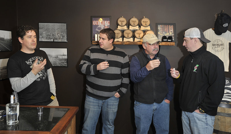 Ned Wight, left, founder and owner of New England Distilling, tells of the family legacy that gave him the idea to resurrect a distillery and produce fresh, creative and different types of gin, rum and whiskey, as three members of the Pour Tour, from left, Jeremy Miller, David Lamarre and Adam Lamarre, taste and discuss the Ingenium Dry Gin.