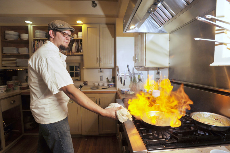 In the kitchen at 91 South in Gorham, chef Noah Gaston applies the flame to a Greek cheese appetizer called saganaki.