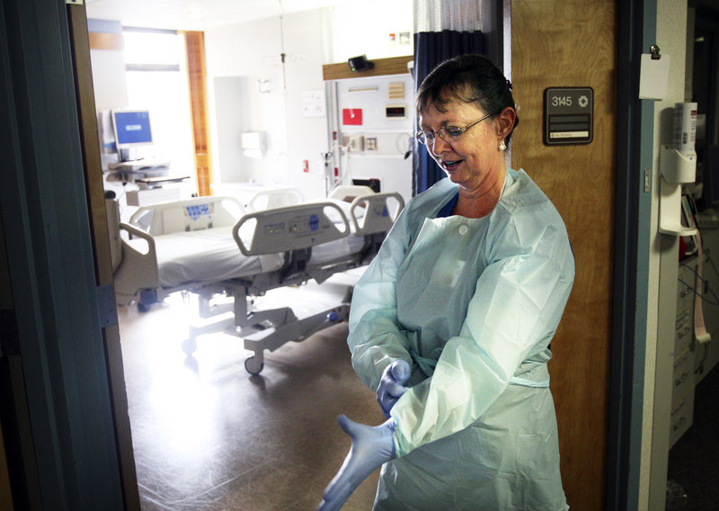 A nurse in Salem, Ore., dons a protective gown, gloves and mask as she enters the room of a patient with a MRSA infection. Overreliance on antibiotics encourages drug-resistant bacteria like MRSA, a state health official says.