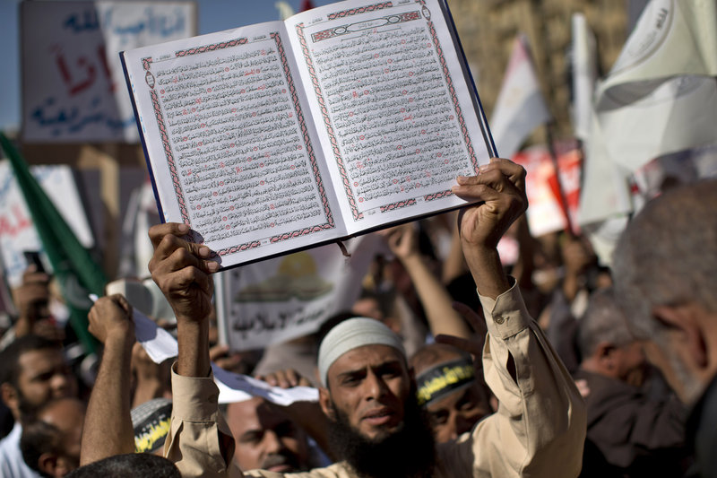 An Egyptian Muslim man holds the Quran, Islam’s holy book, during a rally that drew thousands of ultraconservative Muslims to Tahrir Square on Friday.