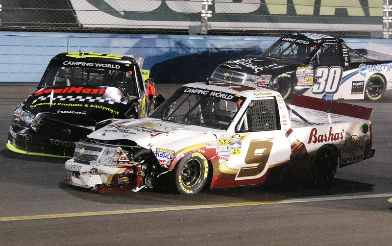Johnny Sauter, left, collides with Ron Hornaday Jr., center, as Nelson Piquet Jr., slides past unscathed on the 66th lap of the Camping World Truck Series race Friday at Avondale, Ariz. Brian Scott won the race, while James Buescher retained the points lead with one race left.