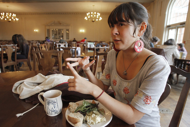 Meiko Lunetta, a vegetarian, talks to a reporter in the dining hall at Green Mountain College. She supports the college’s decision.