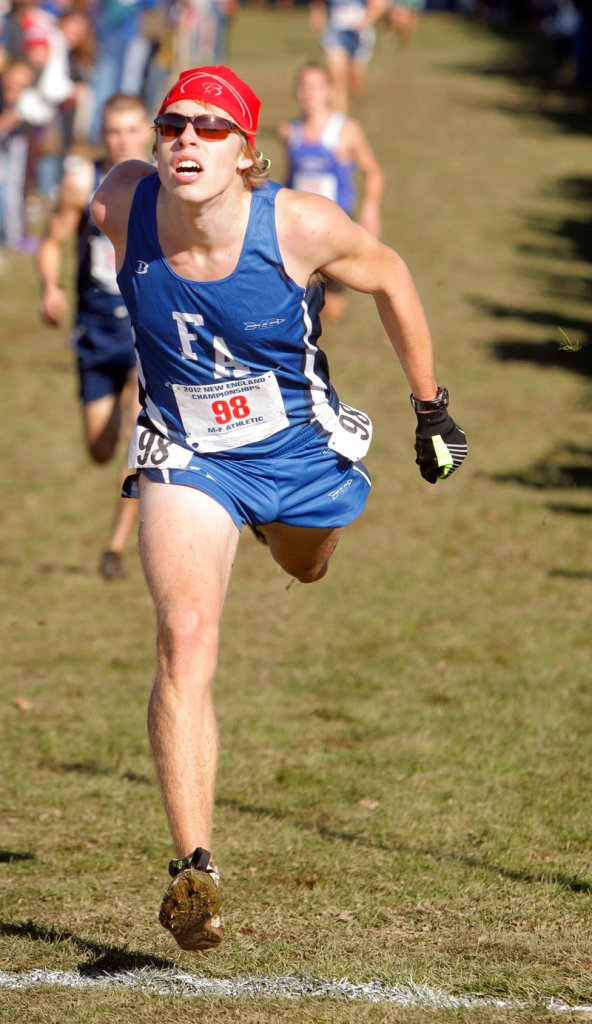 Fryeburg’s Silas Eastman lunges for the finish line to take third place at the New England high school cross country championships.