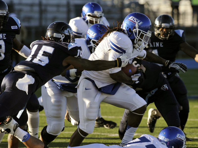 Maine safety Jamal Clay tries to bring down Georgia State running back Roosevelt Watson during’s Saturday’s game in Orono. Clay had two of Maine’s four interceptions in a 51-7 victory.