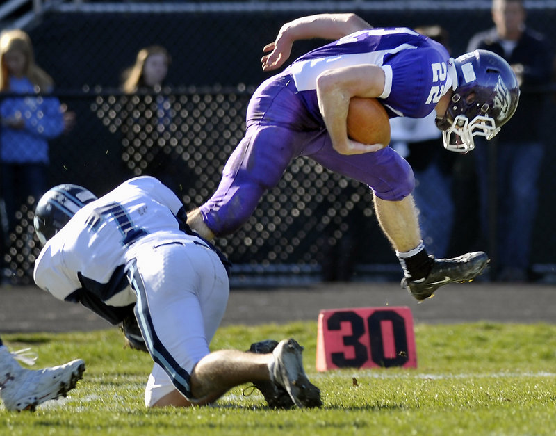 Marshwood quarterback Cameron Roll, who rushed for 105 yards, is brought down by Jordan Pidgeon of York.