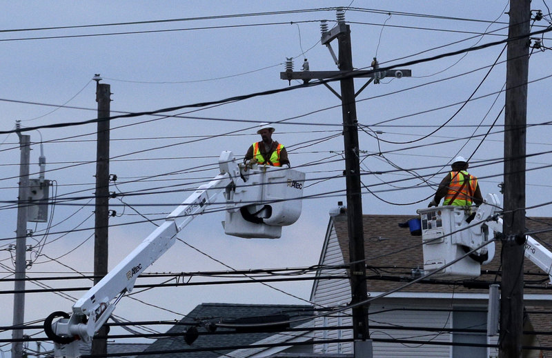 Utility crews work on power lines Nov. 1 in response to Superstorm Sandy as dusk falls in Ship Bottom, a community on Long Beach Island, N.J. New York Gov. Andrew Cuomo has called for investigation of the region’s utilities, criticizing them as unprepared and badly managed.