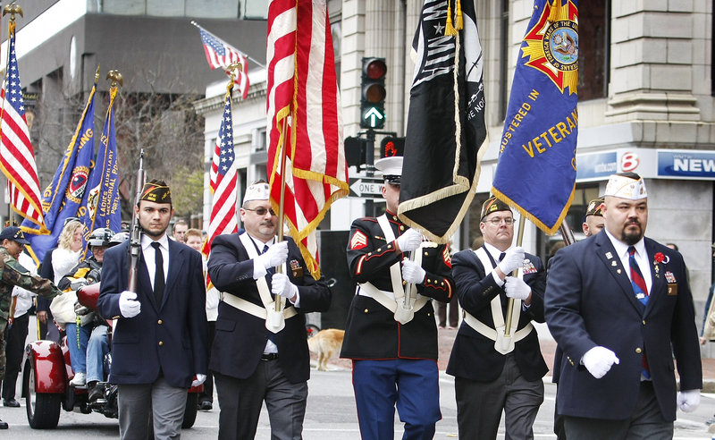 Members of Deering Memorial VFW Post 6859 color guard marches along Congress Street during the Portland Veterans Day parade Sunday. Homelessness among veterans is a growing problem in Portland and cities throughout America.