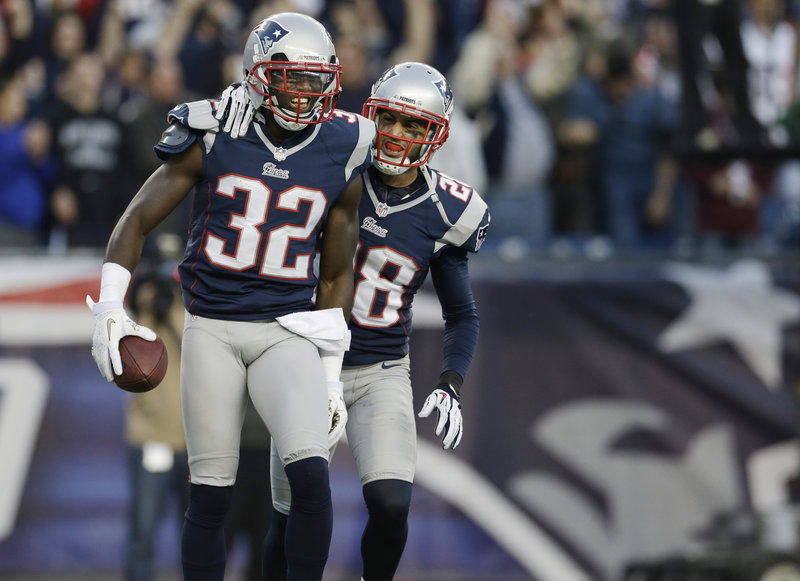 Devin McCourty, left, celebrates his game-saving interception with safety Steve Gregory late in the fourth quarter when the Bills were in position to upset the Patriots in Foxborough.