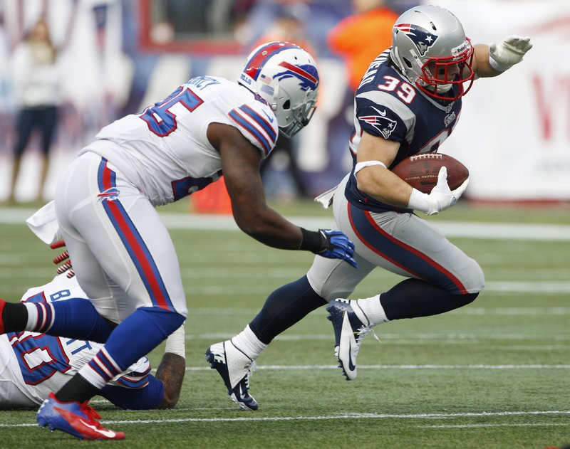 Danny Woodhead swerves around Buffalo safety Da’Norris Searcy during first-half action of Sunday’s game in Foxborough, won by the Patriots 37-31.