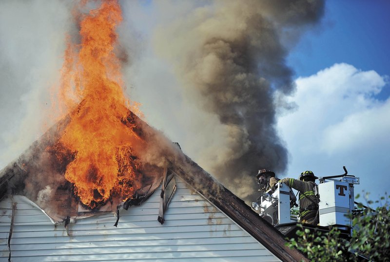 Waterville firefighters battle a blaze that left Jeff and Janet White homeless in August.