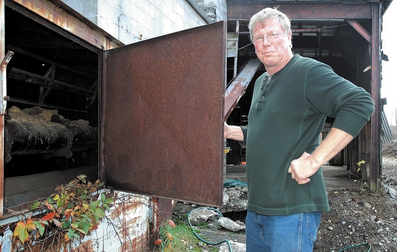 Jay Strickland of Bingham, who recently purchased the former Kennebec Mill, checks out the inside of an old silo on the property recently. “The building is here, and if we don’t do anything with it, it’s just going to fall down. I’m trying to bring Bingham back,” he said.