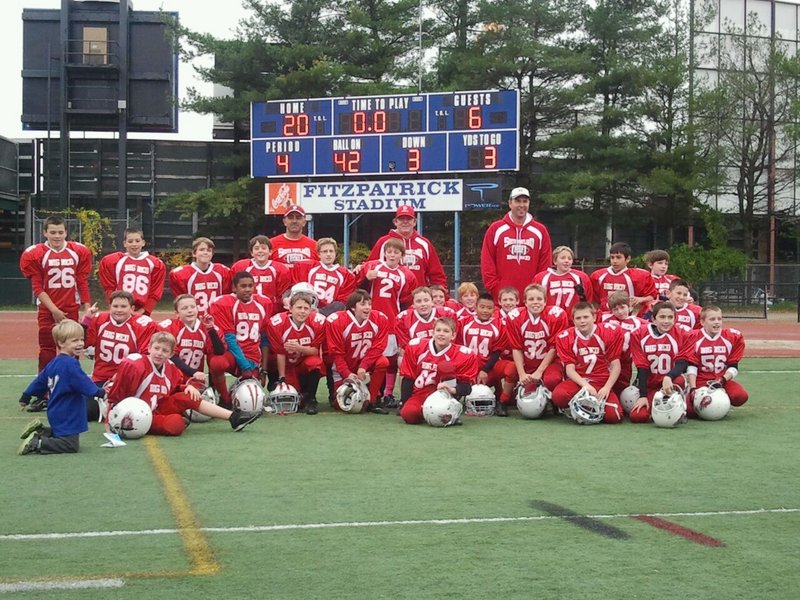 Members of the South Portland Big Red team that won the Maine Youth Football League State Championship, from left to right: Front row – Bradley McMains, Thomas Chaney, Anthony Poole, Eric Walker, Ryan Boles and Kevin Connor; Second row – Michael Delev, Simon Rascher, Geremi Baez, Sam Rumelhart, Nicholas Borelli, Shamus Cole, Boden Abbott, Walter Clay, Jaden Bao, Dylan Adams, Connor Dobson and Cade Carr; Third row – Corey Gagne, Alex Stevens, Ryan Curran, Andrew Riley, Owen Bean, Noah Dreifus, Tyler Brown, Anthony Napolitano and Kyle Rand. Back row – Coaches Tony Napolitano, Jim McDonald and Joel Rumelhart.