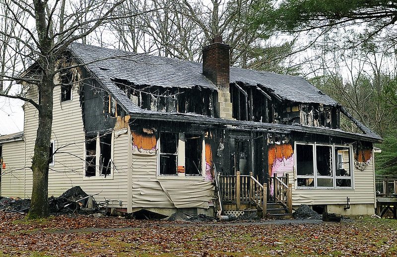 This house at 580 Dow Road in Orrington, scene of a multiple-fatal fire Saturday, stands charred from the inside out on Tuesday.