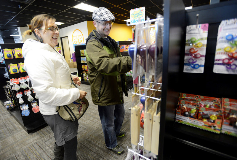 Jessica Wienke and David Wilson of South Portland look over merchandise Wednesday in the toy section of the new Bull Moose store in Mill Creek. It’s in the former Blockbuster building on Waterman Drive.