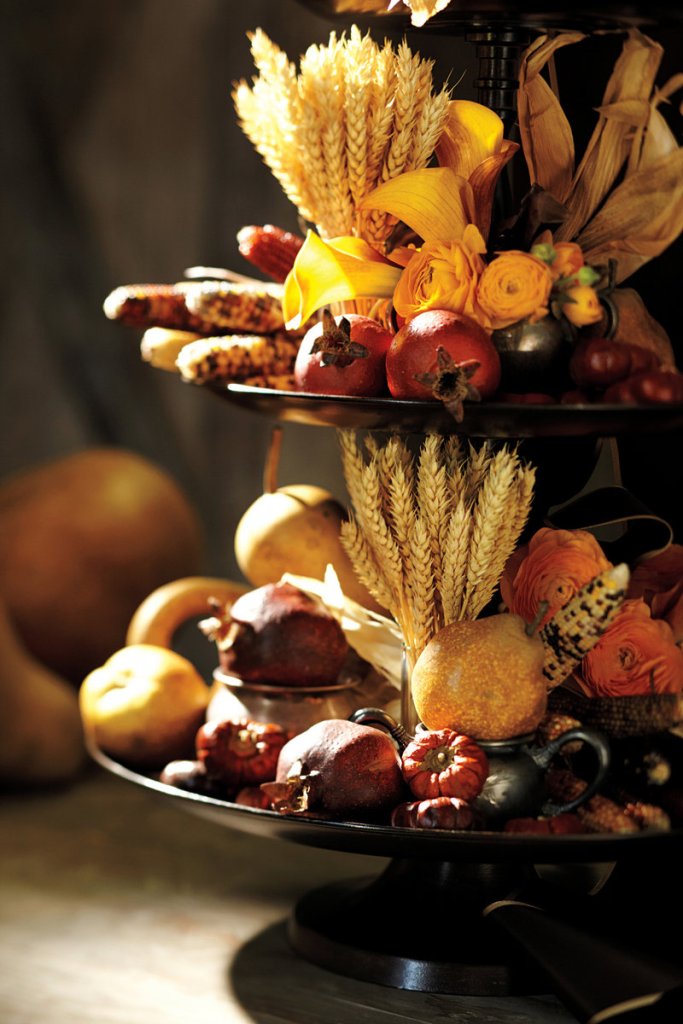 Realistic, long-lasting faux fruits and vegetables are great additions to a multi-tiered cornucopia arrangement.