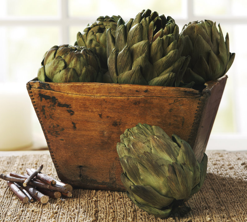A collection of faux artichokes from Potterybarn.com offers a rustic alternative to a more traditional cornucopia look.