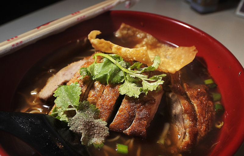 A bowl of noodles with crispy duck and five-spice broth at Pom’s Thai Taste in Portland.