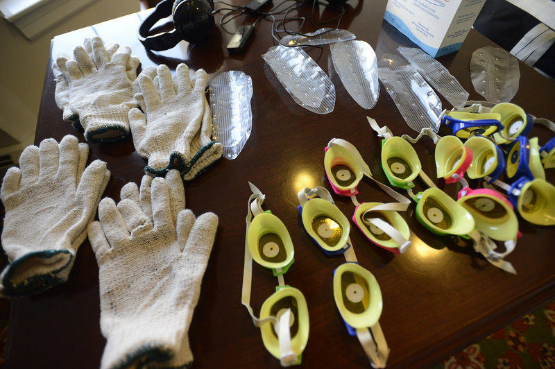 Devices used to simulate the symptoms of dementia during a Virtual Dementia Tour at Piper Shores in Scarborough include goggles, gloves, headphones and shoe inserts.