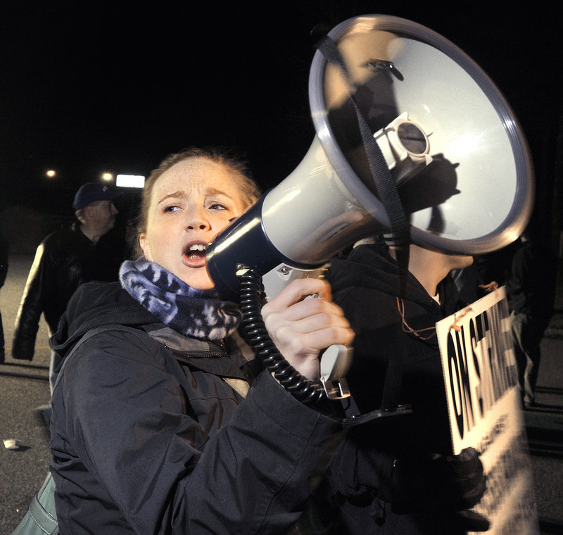Tracy Allen Urquhart, from Hallowell, uses a megaphone to lead chants during the strike.