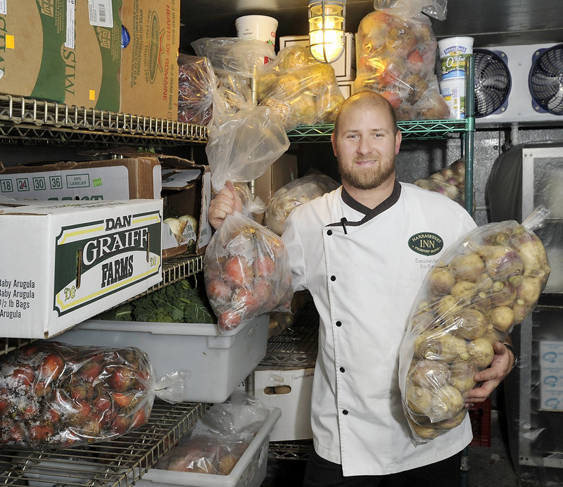 Chef Eric Flynn poses with some of the 800 pounds of potatoes he ordered for Thanksgiving dinner at Freeport’s Harraseeket Inn.