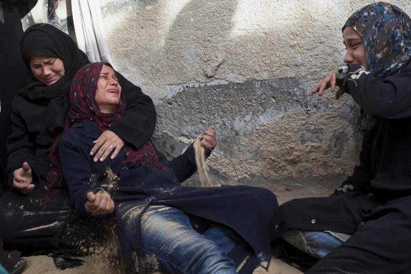 Palestinian women cry at a funeral Friday for two people killed in an Israeli airstrike in Beit Lahia, north Gaza.