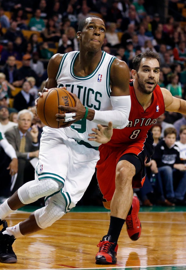 Rajon Rondo drives to the basket past Jose Calderon of the Toronto Raptors in the first quarter of Saturday’s game in Boston, won by the Celtics, 107-89.