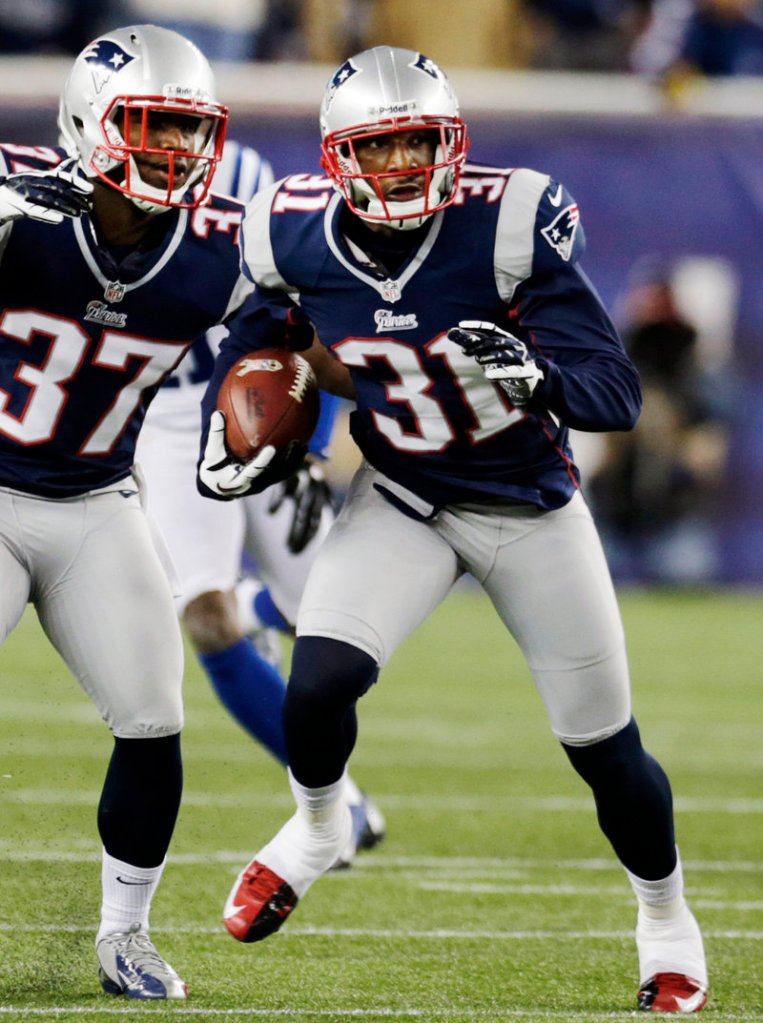 Aqib Talib, in his first game as a New England Patriot, returns an interception for a touchdown while fellow cornerback Alfonzo Dennard watches during first-half action.