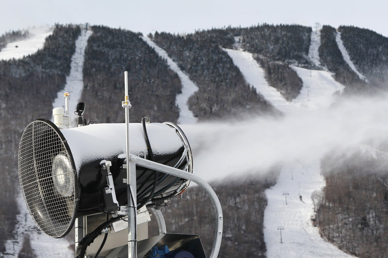This Nov. 15, 2012 photo shows a snow gun making fresh snow at the Stowe resort in Stowe, Vt. The ground might be bare, but ski areas across the Northeast are making big investments in high-efficiency snowmaking so they can open more terrain earlier and longer. (AP Photo/Toby Talbot)